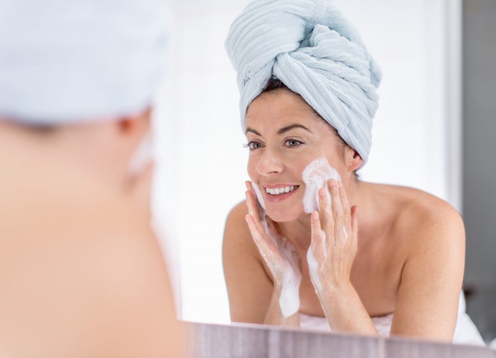 woman washing her face